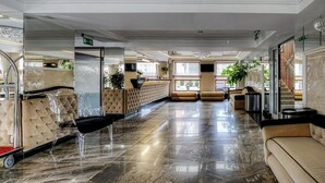 A spacious lobby with a marble floor, seating areas, and a reception desk. - M Hotel Sosnowiec (Sosnowiec)