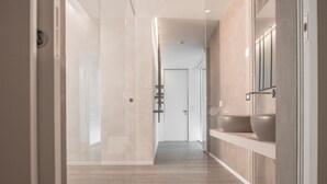 A modern bathroom with a large mirror, a sink, and a shower area. - Hotel Sans Souci (Gabicce Mare)