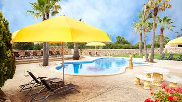 Una piscina al aire libre de temporada, sillones reclinables de piscina