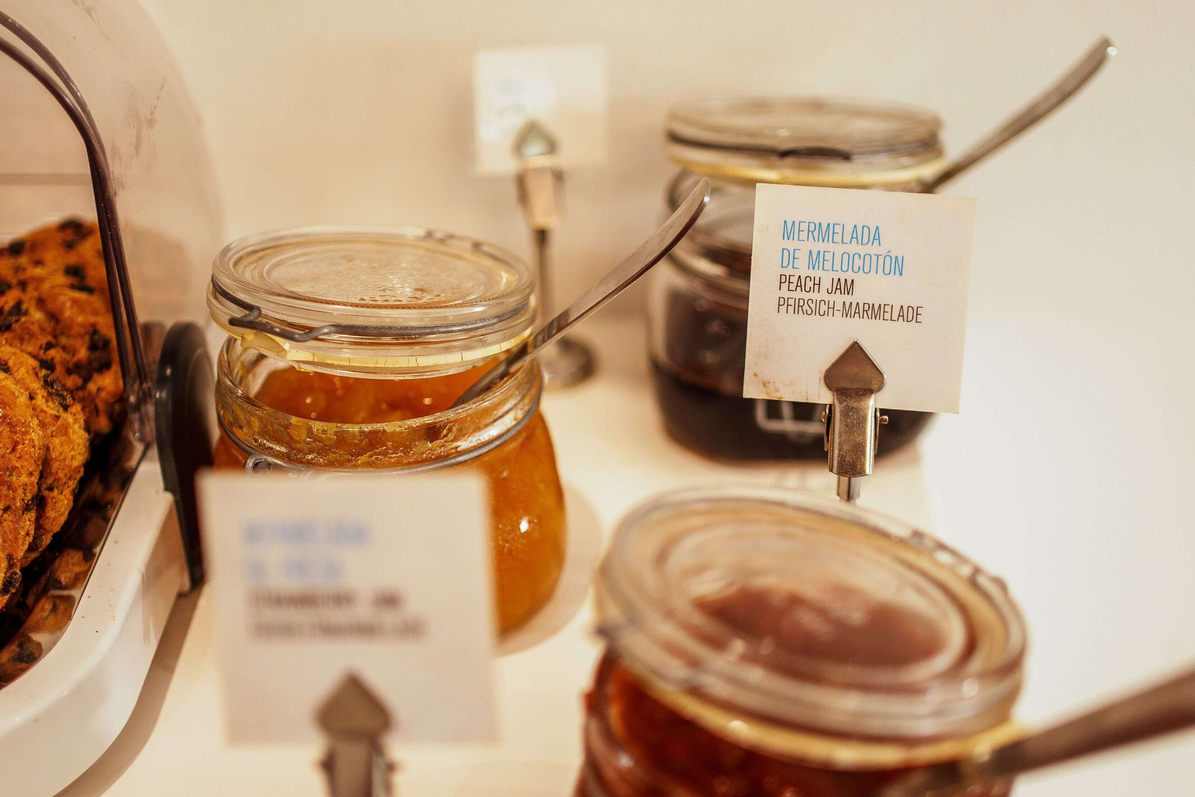 A display of various jams with labels in a store.