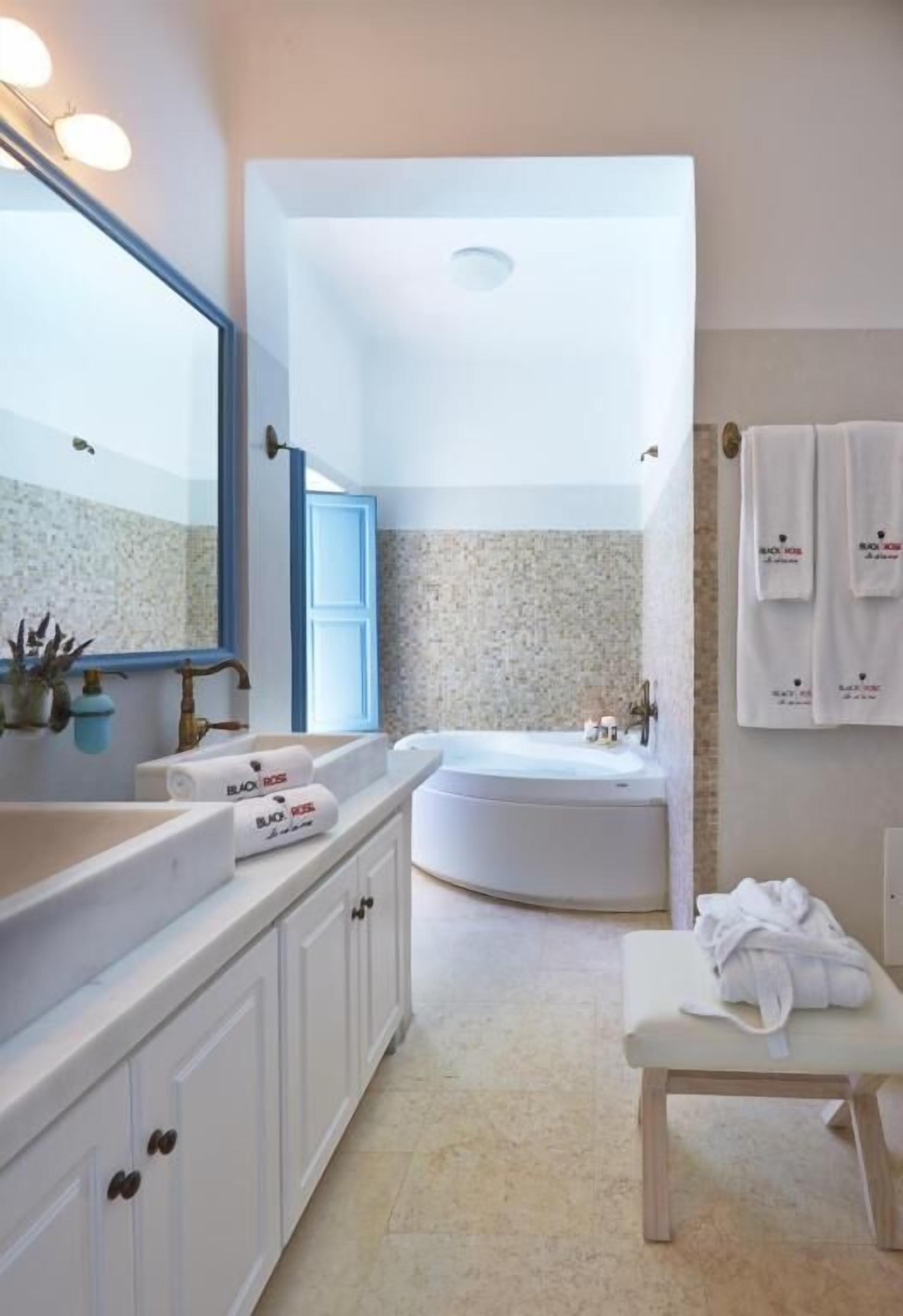 luxury studio suite | bathroom | jetted bath, designer toiletries, hair dryer, bathrobes