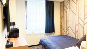 A hotel room with a bed, a desk, a television, and a window with curtains. - HOTEL LiVEMAX Chofu-Ekimae (Chofu)