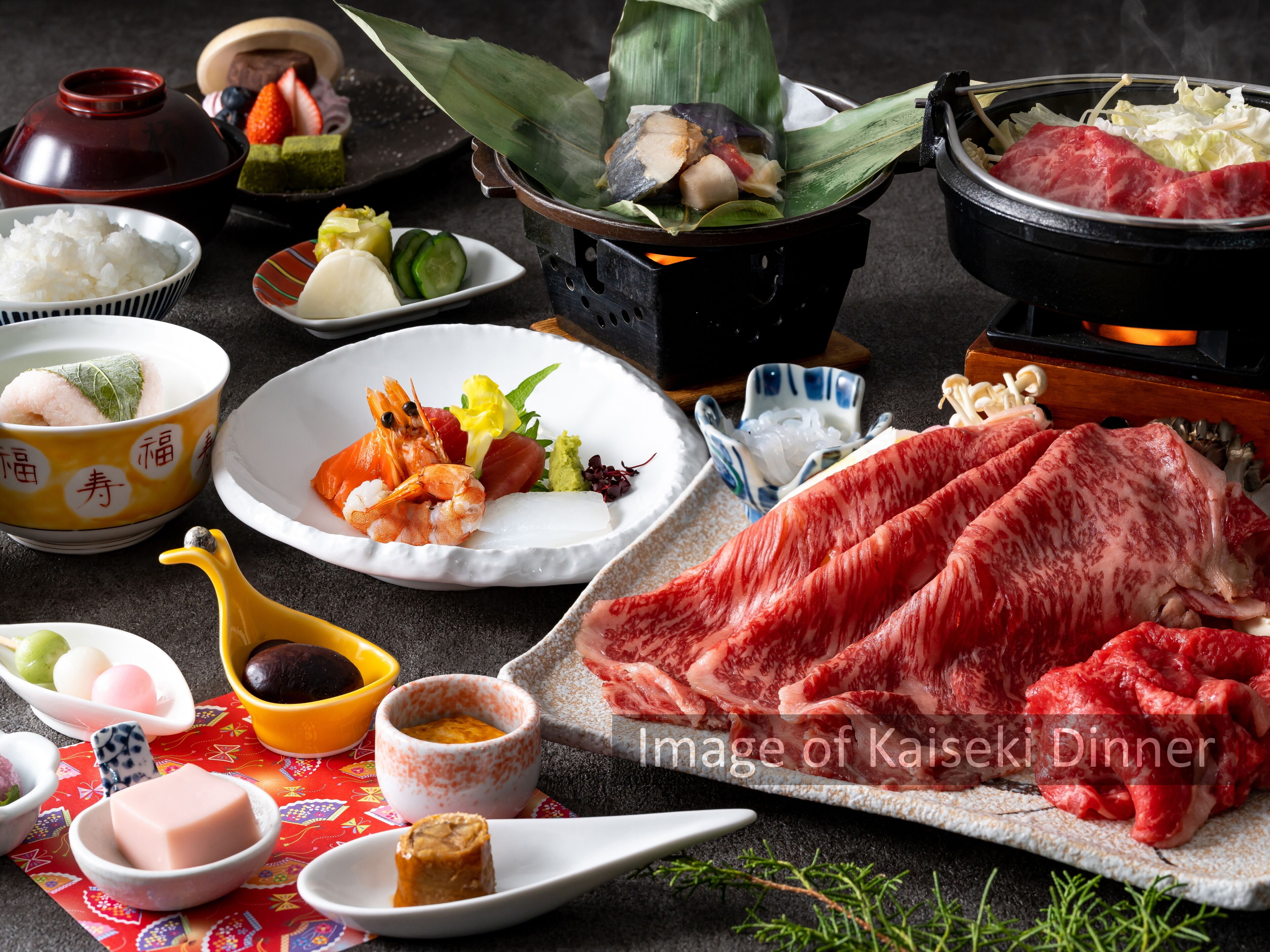 A Kaiseki dinner with various dishes including sashimi, vegetables, and rice.