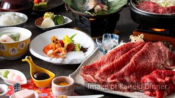 A Kaiseki dinner with various dishes including sashimi, vegetables, and rice.