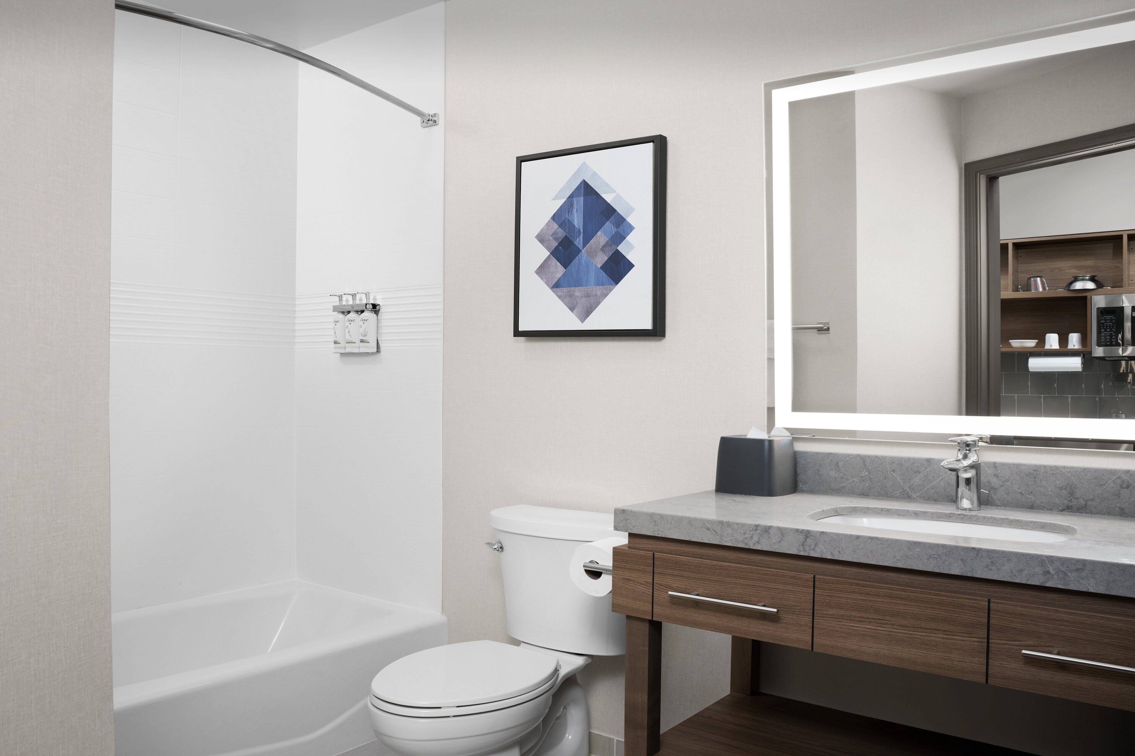 Un baño moderno con bañera, inodoro y tocador.