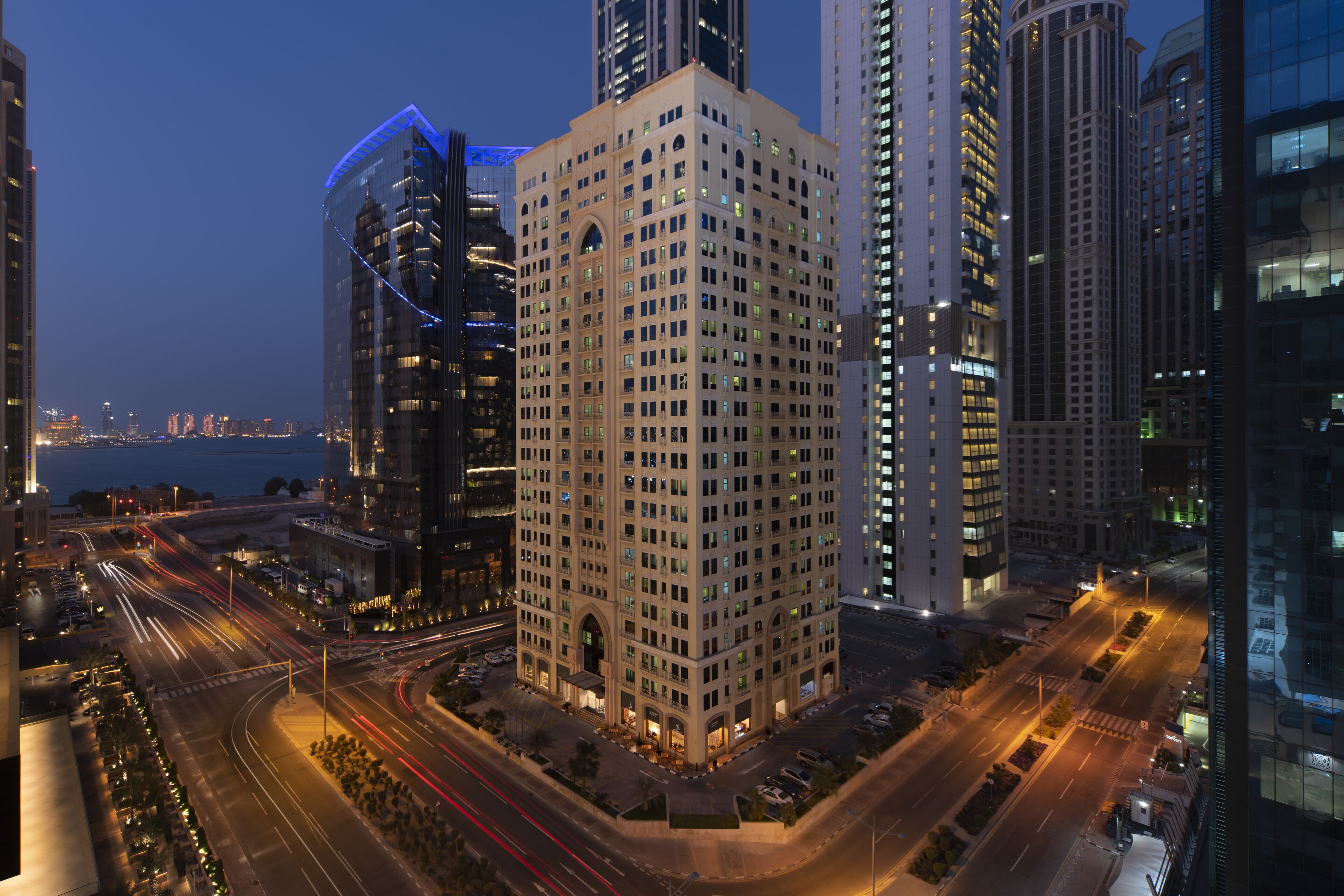 A high-rise building with a central courtyard, surrounded by other tall buildings.