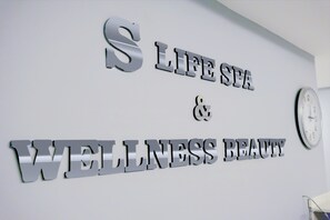 A wall with the text "LIFE SPA & WELLNESS BEAUTY" in metallic letters. - Holiday Inn Ankara - Kavaklidere by IHG (Ankara)