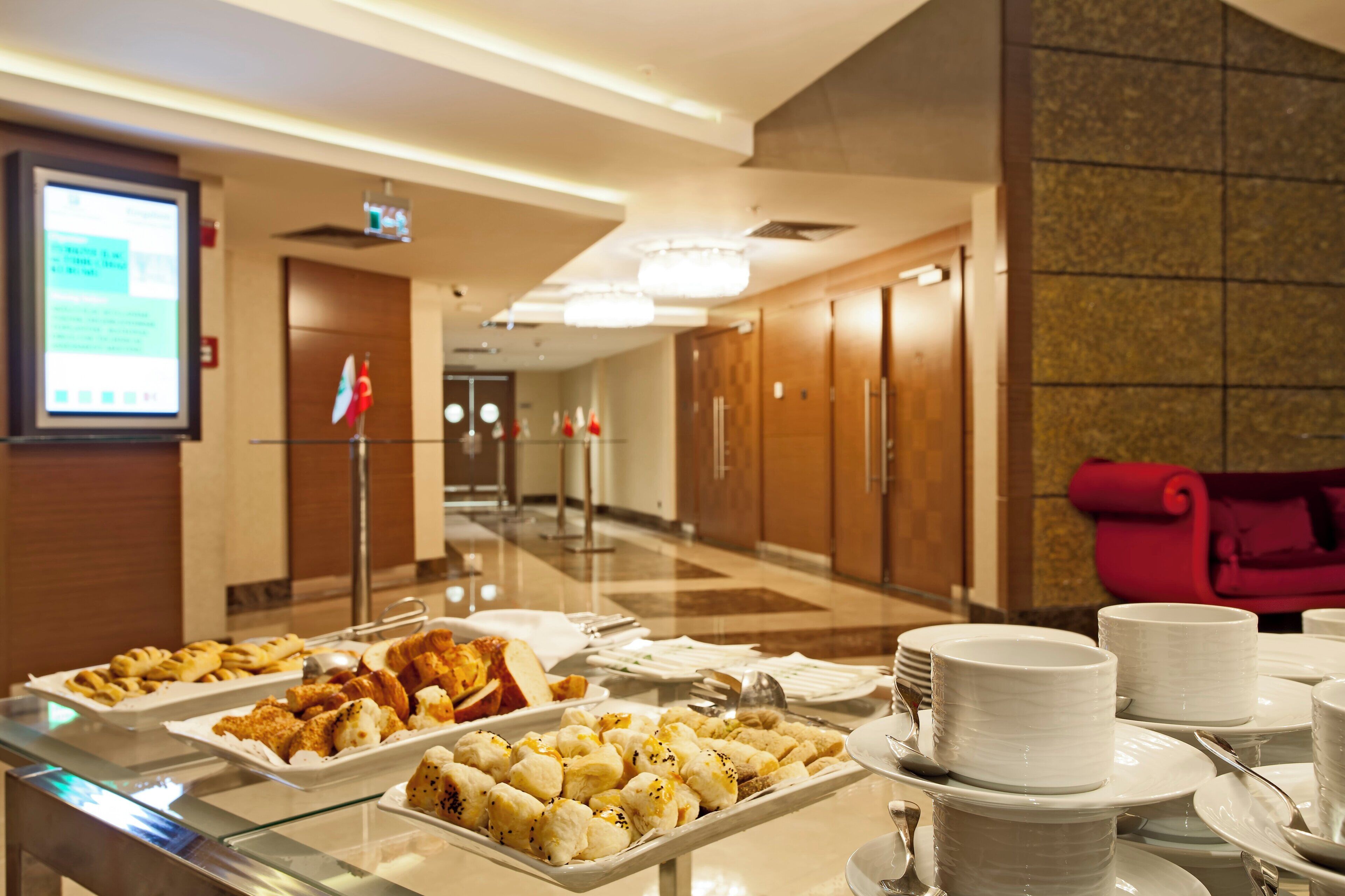 A buffet setup with various food items and dining ware.