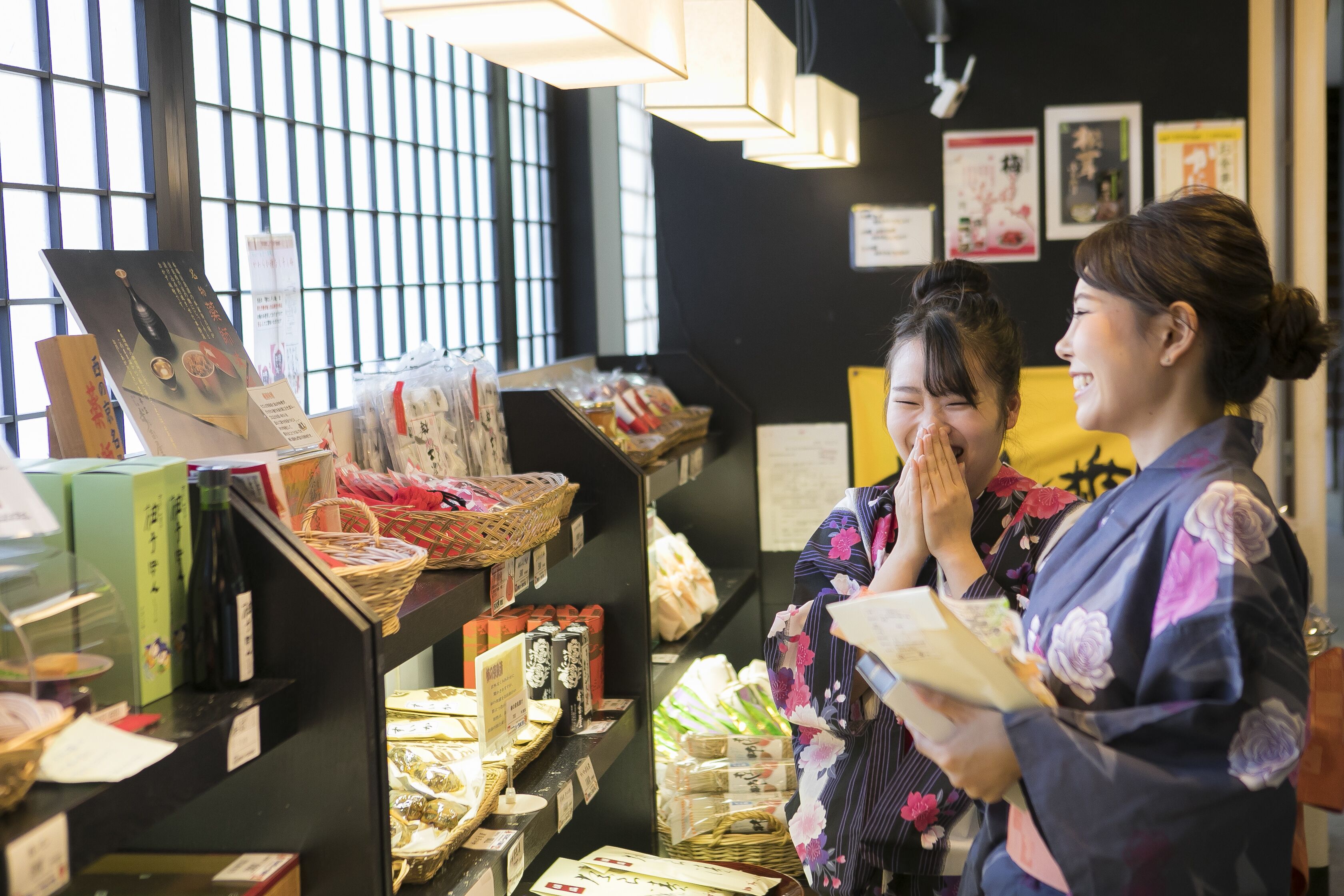 A traditional Japanese store with shelves of packaged goods and a display of tea sets.