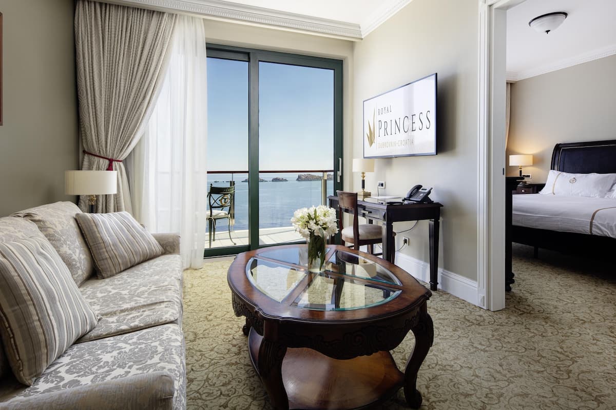 deluxe suite, 1 king bed with sofa bed, balcony, sea view | living area | 140-cm lcd tv with satellite channels, tv, fireplace