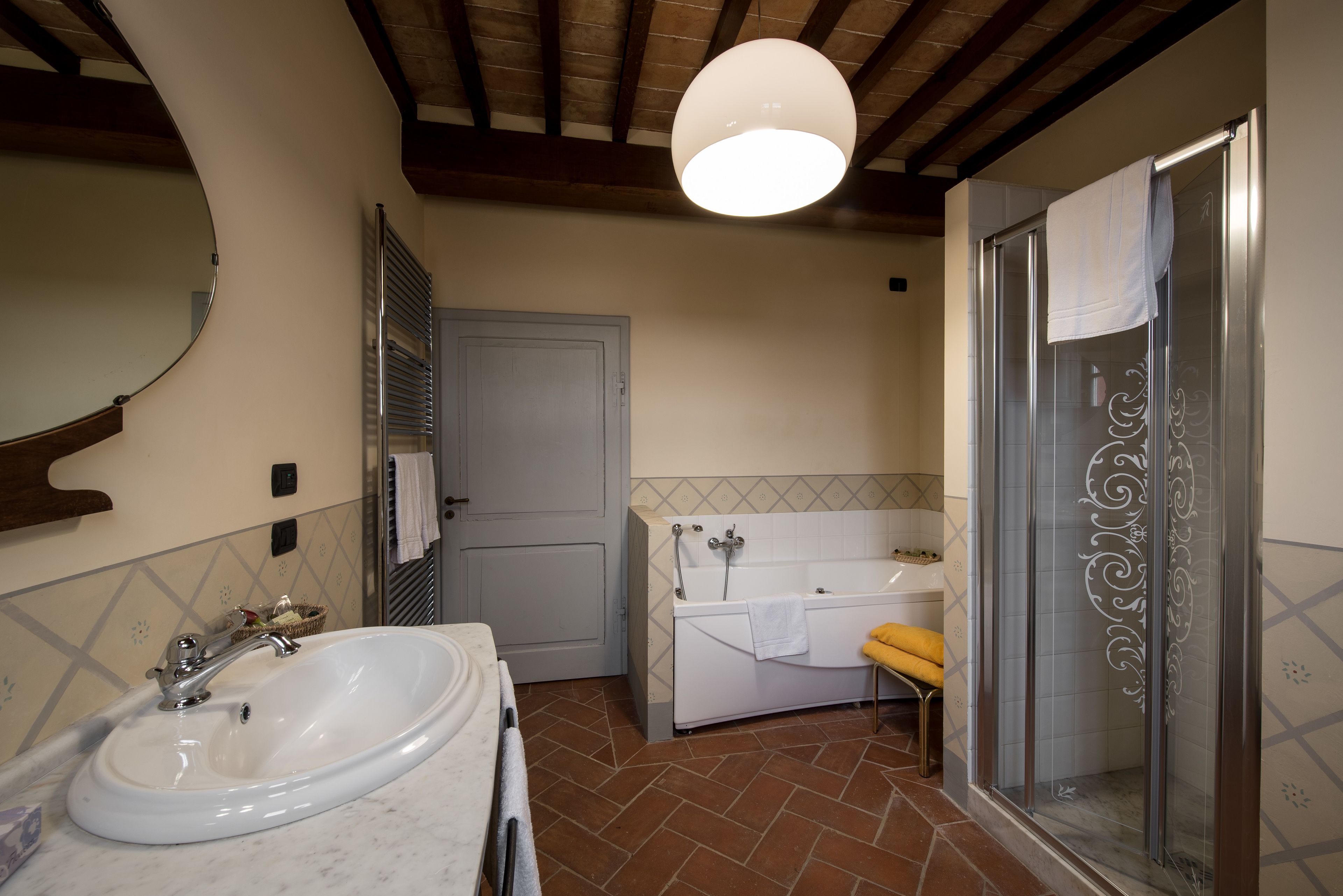 A bathroom with a sink, bathtub, and shower.