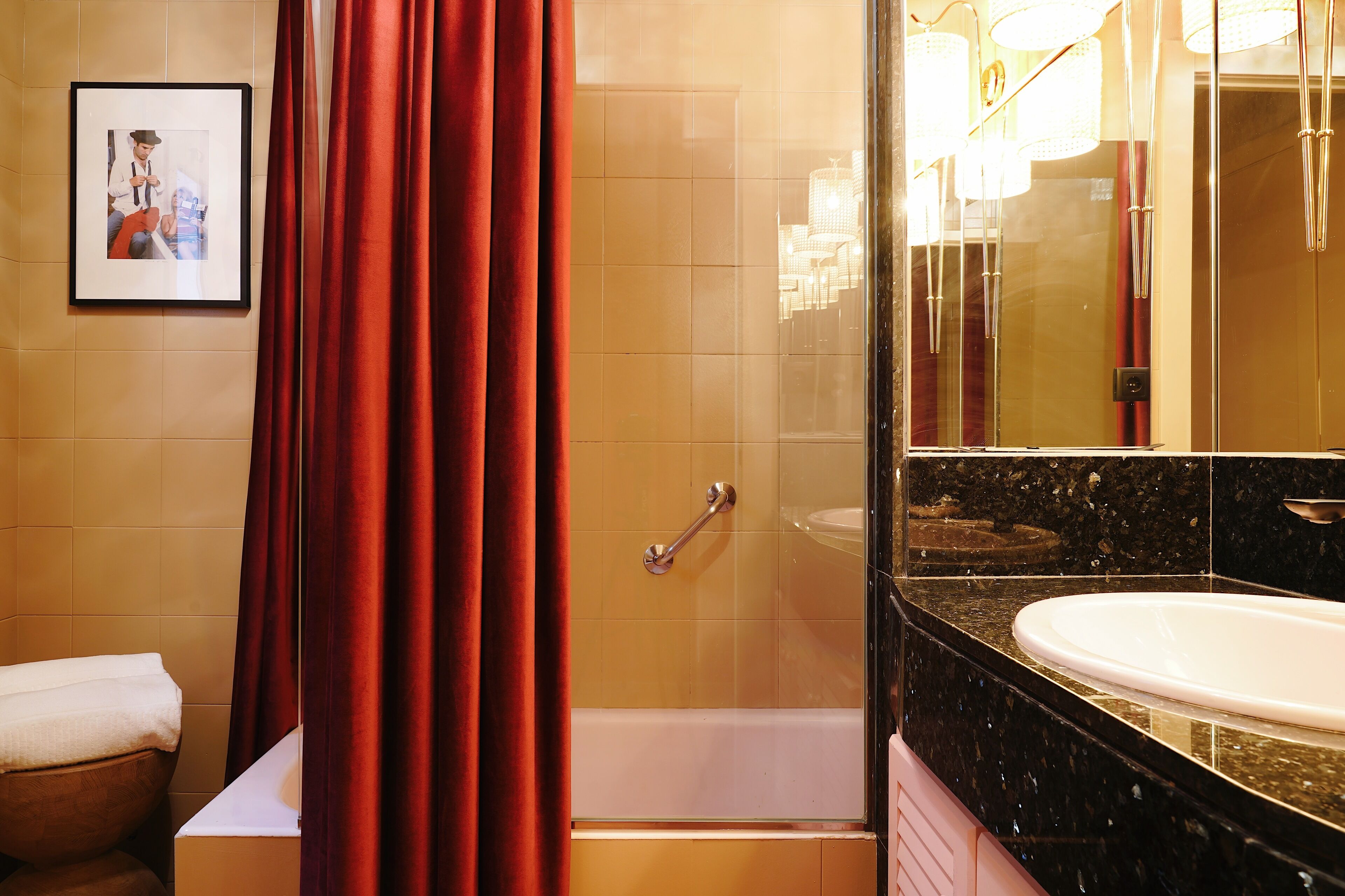 A bathroom with a bathtub, a shower, and a sink.