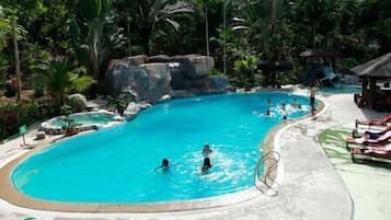 Relax by the resort's oval-shaped pool surrounded by lush tropical vegetation.
