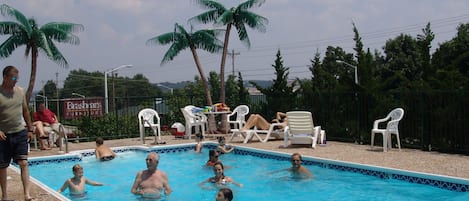 Outdoor pool, open 9 AM to 10 PM, pool loungers