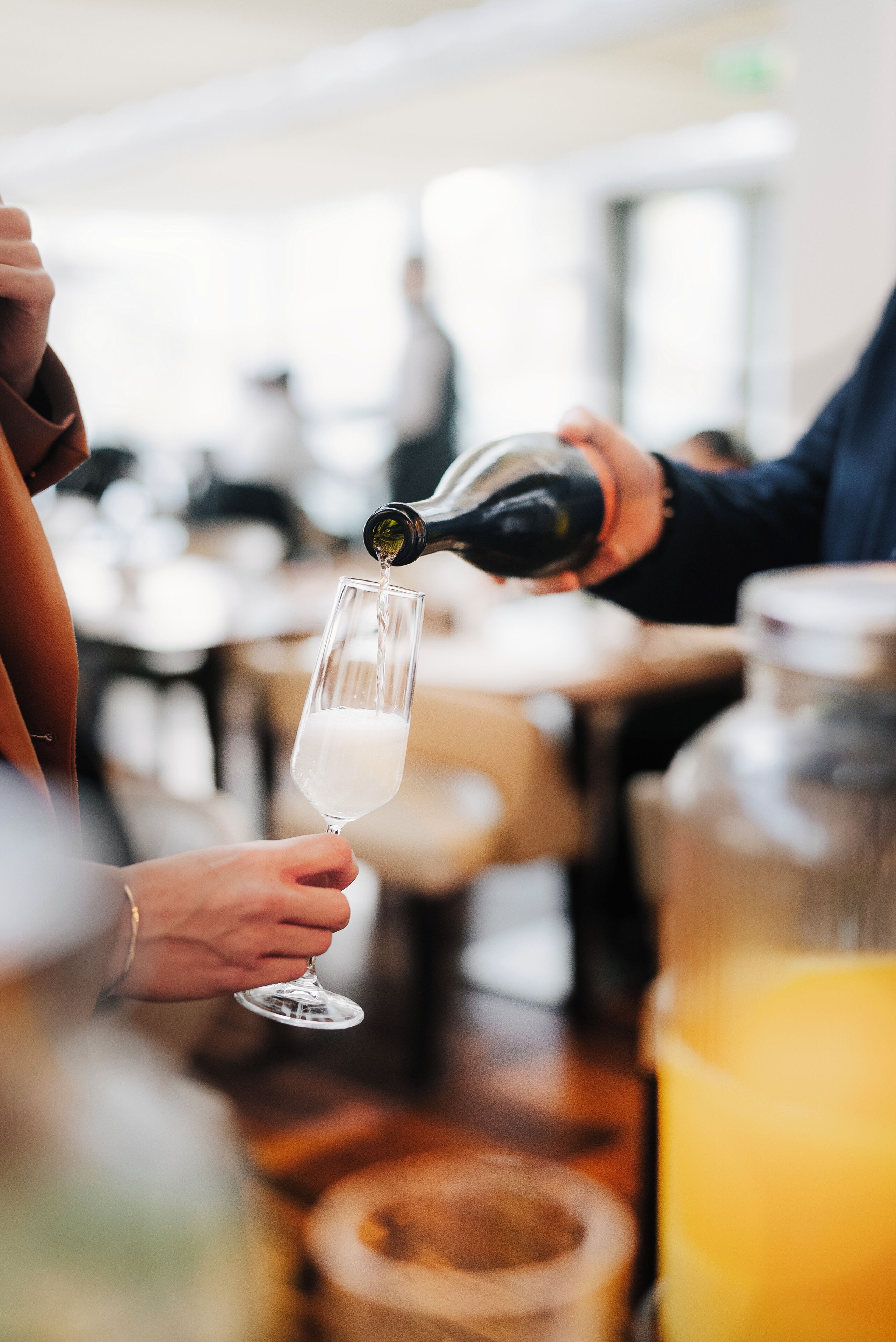 A person pouring a drink into a glass.