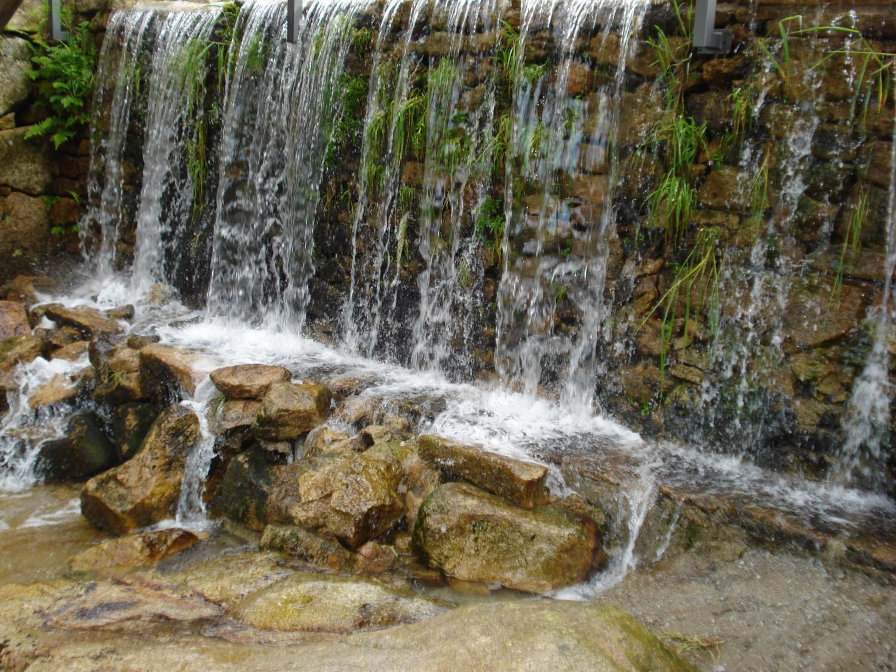 A waterfall cascading over rocks in a natural setting.