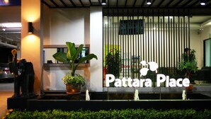 A reception area with a sign reading "Pattara Place," a potted plant, and a statue of a person. - Pattara Place (Chiang Mai)
