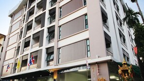 A multi-story hotel with a modern design, featuring balconies on each floor and a ground-level entrance with a sign for "Pattaya Place". - Pattara Place (Chiang Mai)