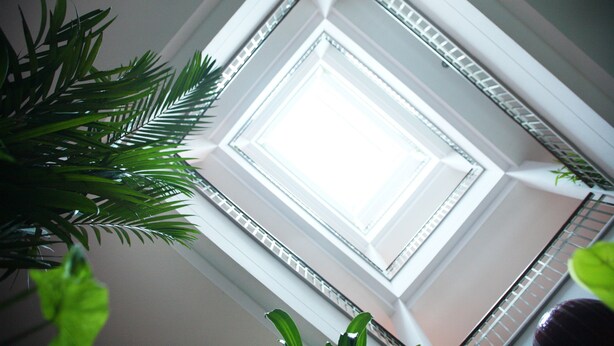 A view of a skylight in a building with a geometric ceiling design and visible structural beams. - Pattara Place (Chiang Mai)