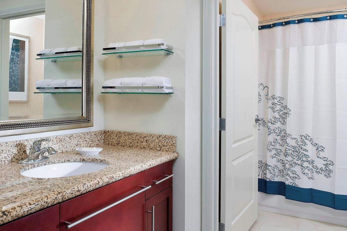 designer toiletries, hair dryer, towels