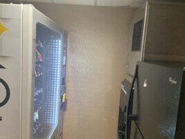 A compact kitchen with a refrigerator, a microwave, and a freezer.