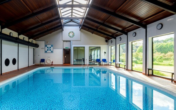 Indoor pool, open 8:00 AM to 8:00 PM, pool umbrellas, pool loungers