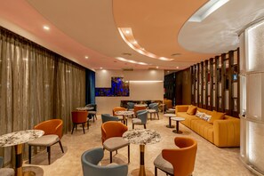 A modern lounge area with multiple seating options including sofas and chairs, and a central area with a unique light fixture. - HOTEL GEIGHT TAIPEI (New Taipei City)