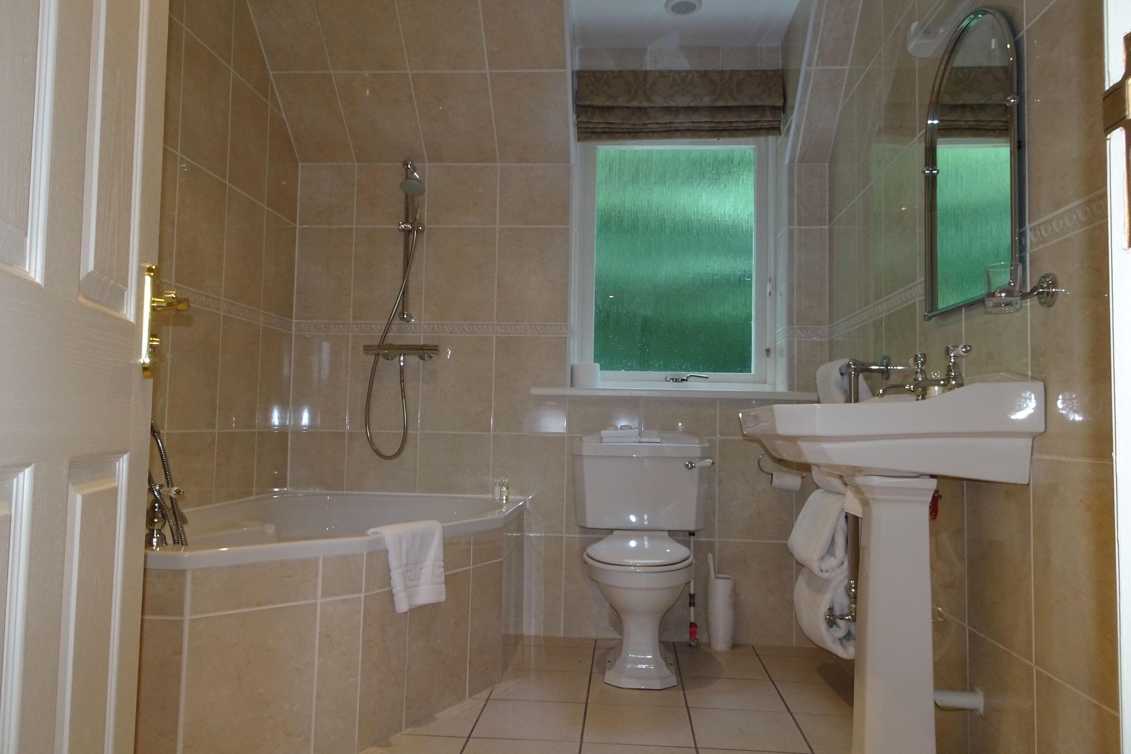 A bathroom with a bathtub, toilet, and sink.