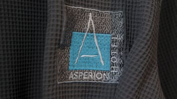 A close-up of a textured fabric with a patch featuring a stylized 'A' and the word 'ASPERION'.