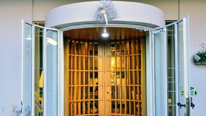A traditional Japanese-style entrance with a sliding door, a wooden floor mat, and a small garden area visible through the door. - Villa Bianca (Sona)