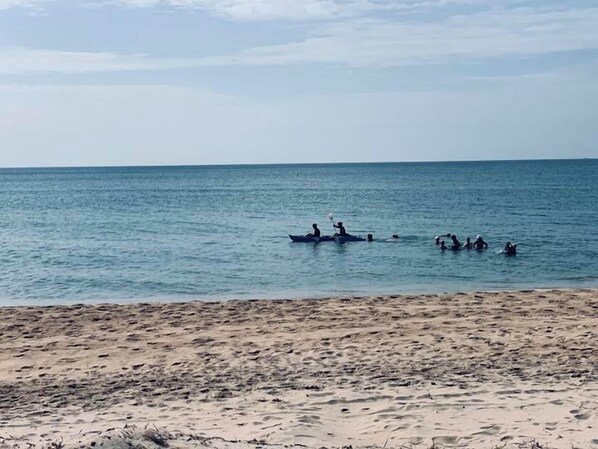 Una playa con arena dorada y mar tranquilo.