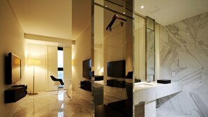 A modern bathroom with a marble floor, a large mirror, a TV, and a hanging shower rod. - Urban Boutique Hotel (Anyang)