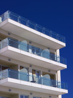 A multi-story building with balconies and large windows. - El Greco Hotel (Ierapetra)