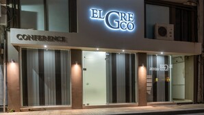 A hotel named "El Greco" with a modern facade, large glass windows, and a sign indicating "Conference" and "Hotel" services. - El Greco Hotel (Ierapetra)