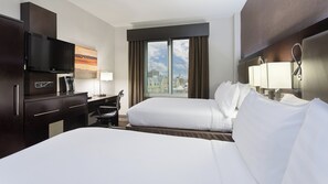 A hotel room with a bed, a desk, a chair, a TV, and a window with a city view. - Holiday Inn NYC - Lower East Side by IHG (New York)