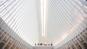 A modern interior with a central atrium, white ribbed columns, and a skylight. - Holiday Inn NYC - Lower East Side by IHG (New York)