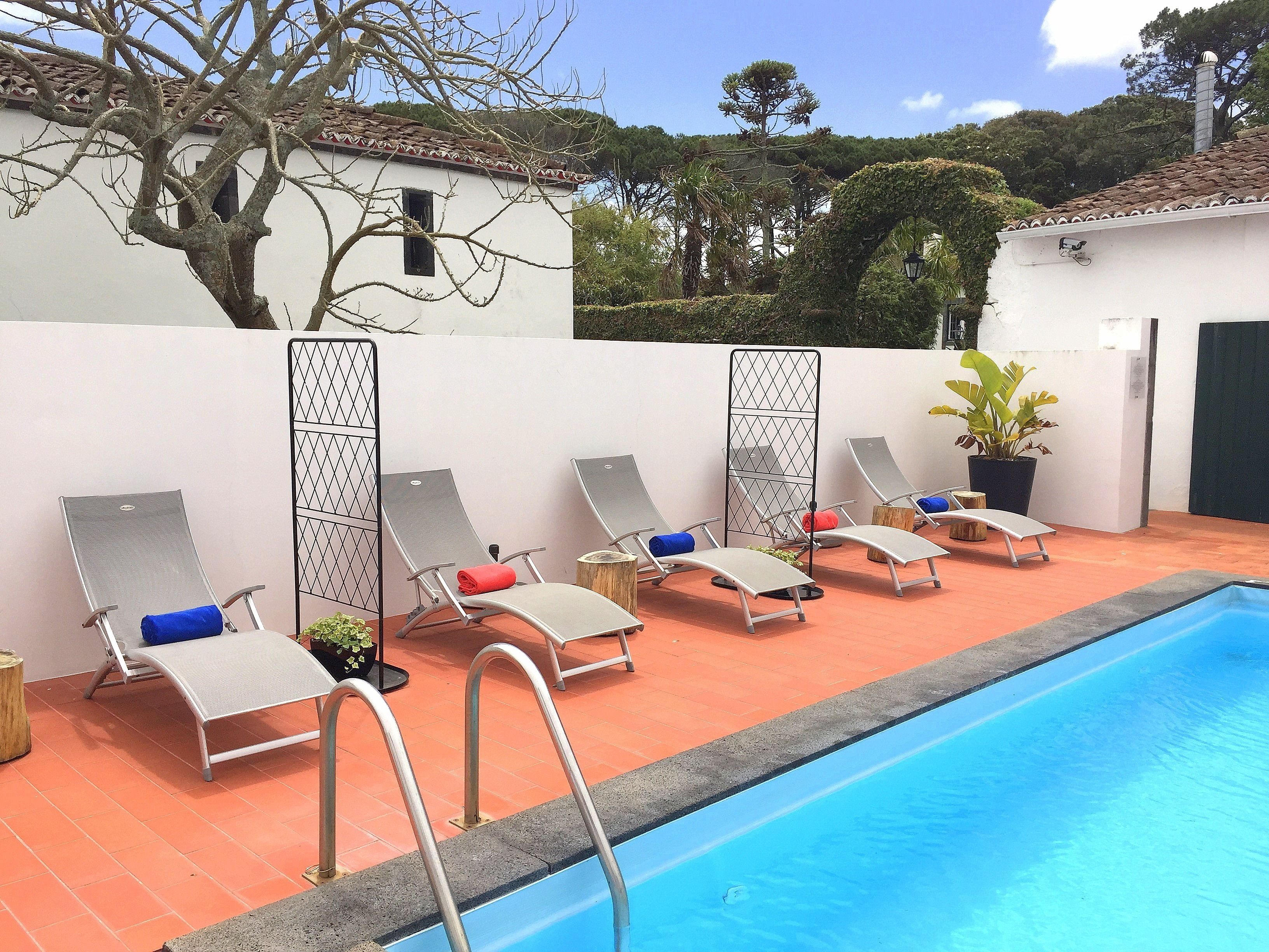 A poolside area with lounge chairs and a swimming pool.