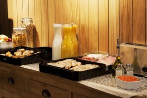 A breakfast buffet with various food items and condiments. - Artrip Hotel (Madrid)