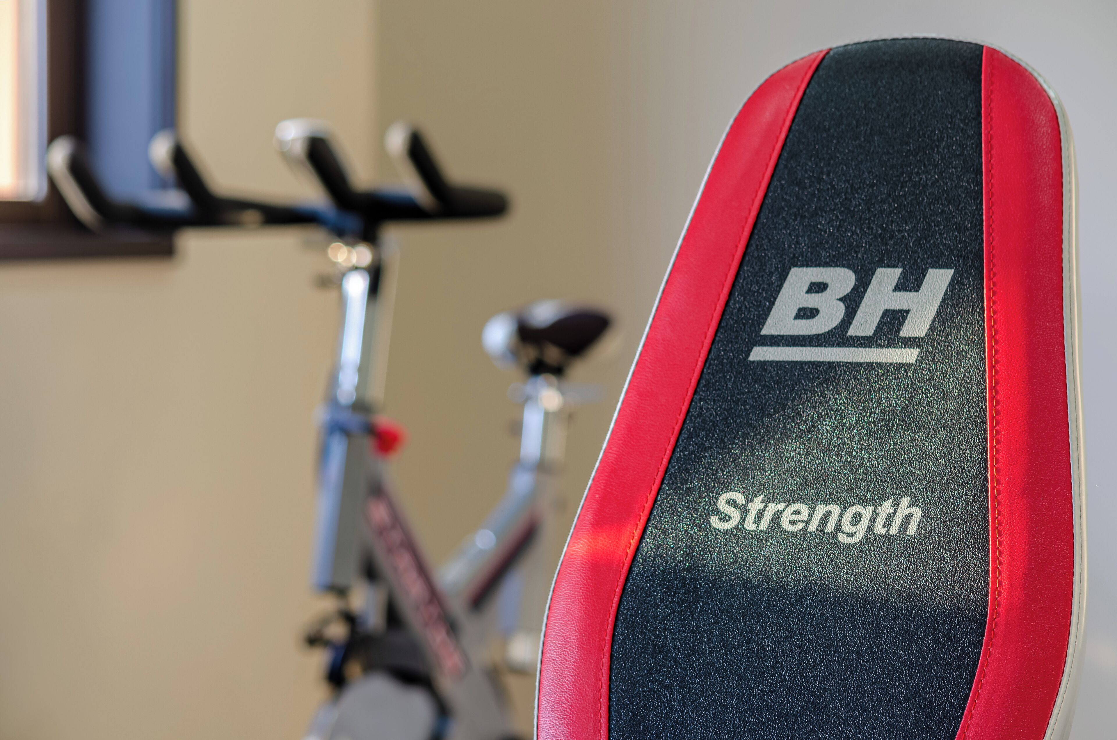 A close-up of a bike seat with the brand "BH" and the word "Strength" on it.