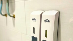 Two wall-mounted hand sanitizer dispensers labeled 'HOTEL Seeds' in a bathroom. - Seeds Hotel Shah Alam Seksyen 7 I-City (Shah Alam)