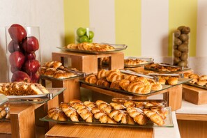 Un bufé con diversas opciones de panadería, incluyendo pasteles y tartas.