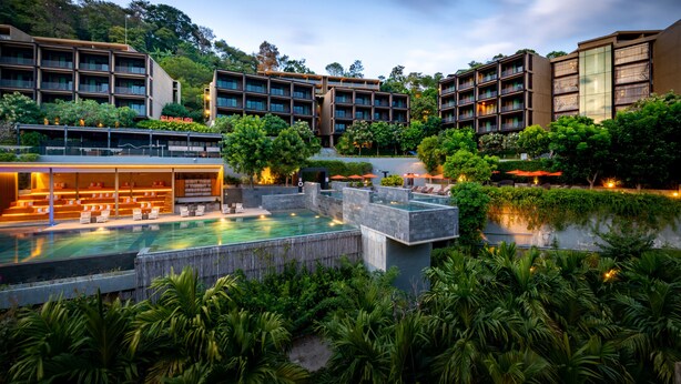 A hotel with multiple buildings, a swimming pool, and lush greenery. - SUNSURI PHUKET, Nai Harn Beach (Rawai)
