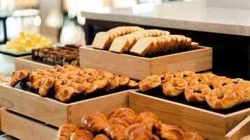 A display of various baked goods in wooden boxes.