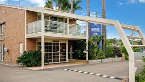 A two-story building with a reception area and a sign for 'WATERS MOTOR INN'.