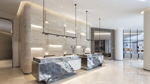 A modern hotel lobby with marble reception counters, pendant lighting, and a spacious layout. - AC Hotel by Marriott Seoul Gangnam (Seoul)