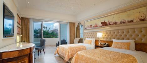 A hotel room with two beds, a sitting area, a large window, and a view of the outdoors.