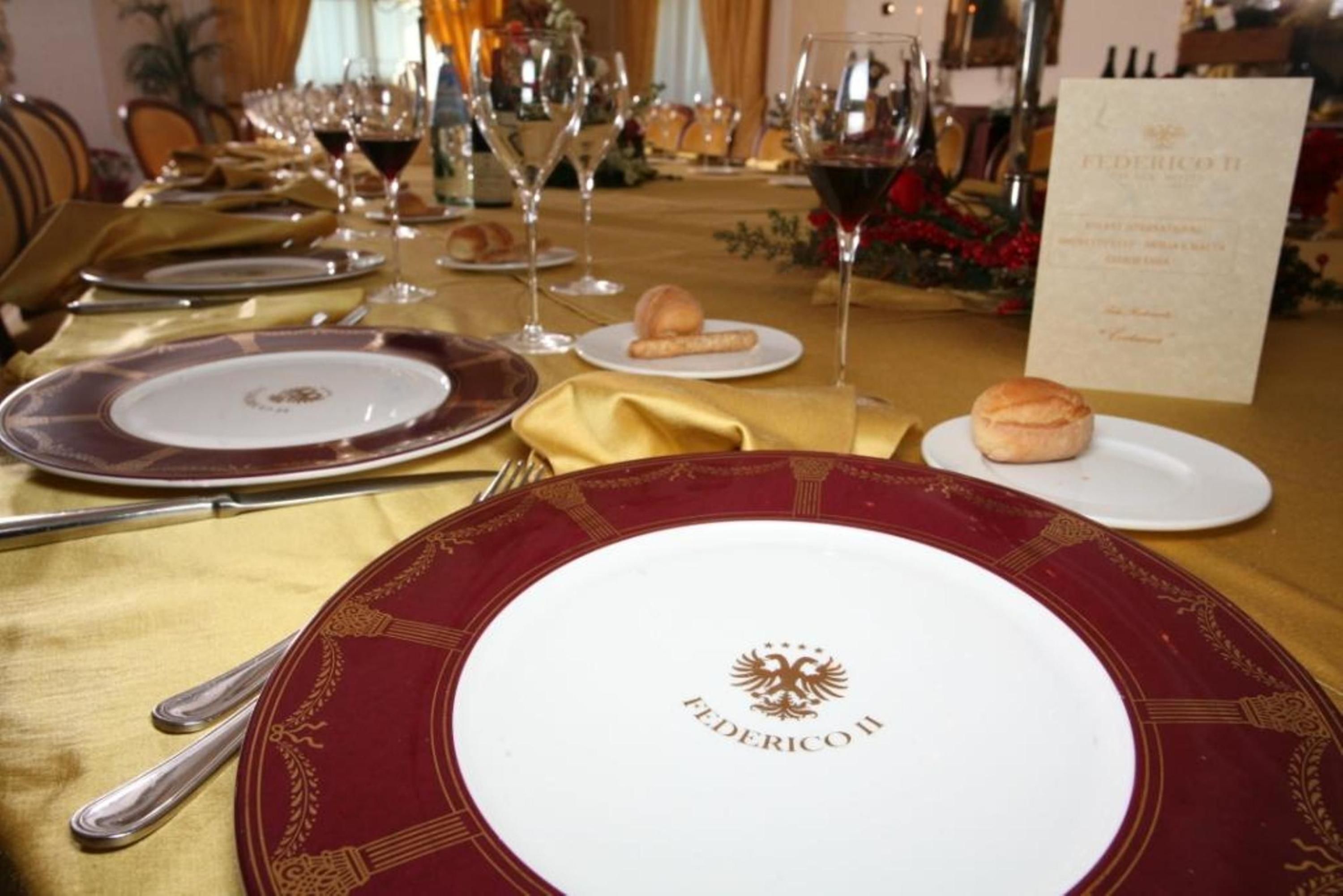 A formal dining table set with plates, glasses, and cutlery, indicating a restaurant or dining area.