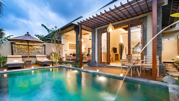 A pool area with lounge chairs and a pergola. - Bliss Bungalow (Ubud)