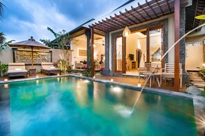 A pool area with lounge chairs and a pergola. - Bliss Bungalow (Ubud)