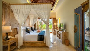 A spacious bedroom with a canopy bed, a bedside table with a lamp, and a view of the outdoors. - Bliss Bungalow (Ubud)